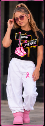 Youth model wearing a black Drip Avenue sneaker graphic shirt, white pants, and pink shoes