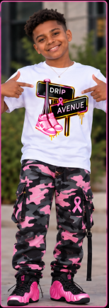 Youth model wearing a white Drip Avenue sneaker graphic shirt, pink camouflage pants, and black-and-pink sneakers