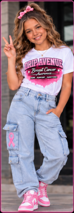 Youth model wearing a white Drip Avenue Breast Cancer Awareness shirt, light denim cargos, and pink sneakers