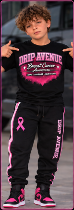 Youth model wearing a black Drip Avenue Breast Cancer Awareness shirt, black track pants, and pink-accented sneakers